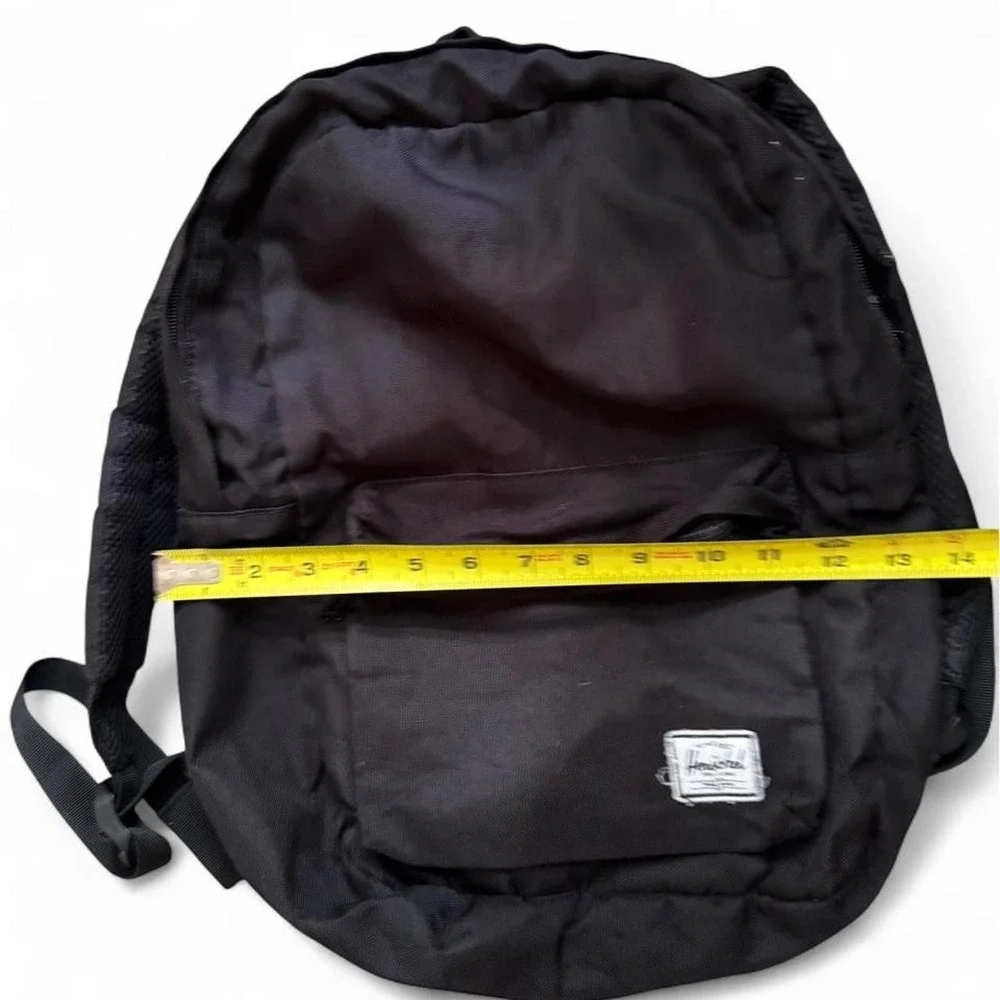 Herschel black backpack with red and white striped interior